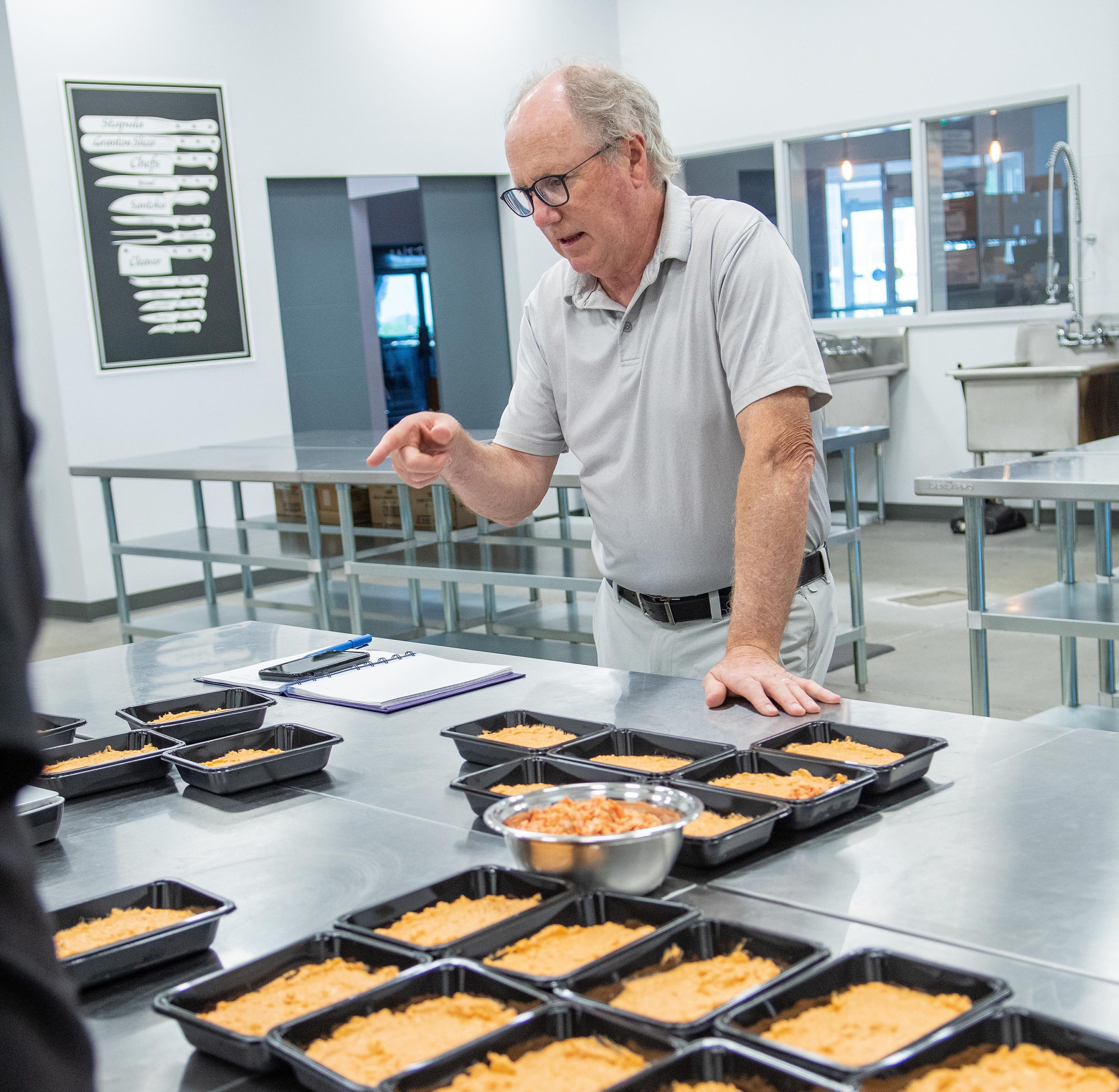 Alan looking over a table of seafood dips.